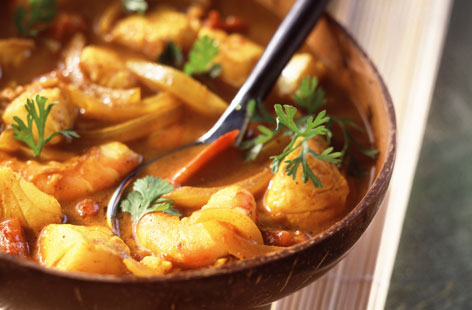 Craving a curry without the calories? Try this aromatic fish soup with fragrant coconut milk and ginger. Onions, ginger and garlic are softened in the pan before being combined with storecupboard spices, any white fish fillet, coconut milk and tomato puree. Curry easy.