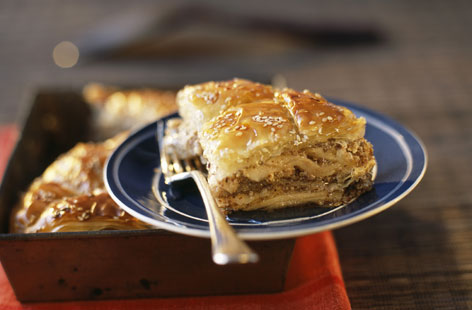 Baklava is a delicious filo pastry dessert filled with chopped nuts and honey. Here it's given a cinnamon and apple twist, making it a perfect autumn treat: Thin slices of apple enveloped in layers of buttered filo pastry and baked, then topped with nuts and syrup.