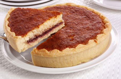 A take on the traditional Jamaican toto, this light and airy coconut cake is resplendent with almonds and raspberry jam.