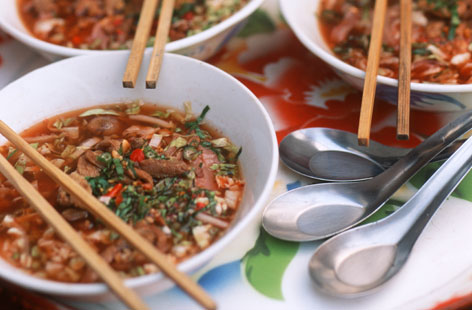 This spicy noodle soup could soon become a midweek staple. Finely sliced pork, shallots and basil in an aromatic broth base flavoured with ginger, garlic and aniseed. Add any cooked rice you may have leftover to thicken the soup and use fish sauce to adjust the seasoning.