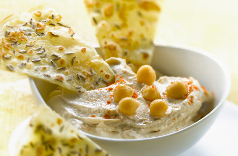 Go beyond cucumber and carrot sticks and try making easy cumin pancakes to dip in speedy homemade houmous. Fried until golden and crisp, these simple pancakes make a delicious healthy snack.