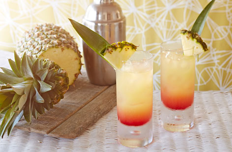 Life's a beach when you're armed with a beautiful Caribbean cocktail. This gorgeous sunset-in-a-glass is made with pineapple, vodka, grenadine and fresh lime juice. Garnish with slices of fresh pineapple and a miniature umbrella.