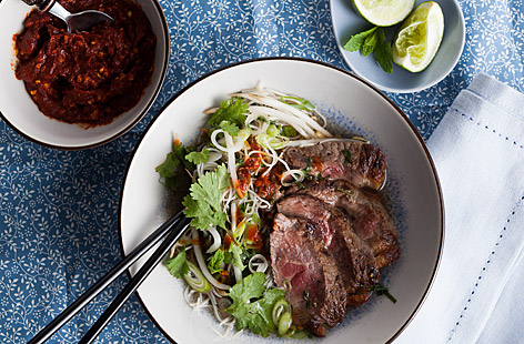 Noodles in a fragrant clear broth topped with tender slices of beef, bean sprouts and fresh herbs