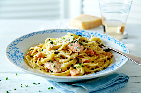 Classic Italian carbonara has been given a tasty twist with the addition of baked salmon and a squeeze of lemon