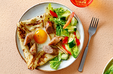 This open pancake recipe is bound to be a hit with the kids. It's topped with sausages and an egg, and makes a great hearty lunch!