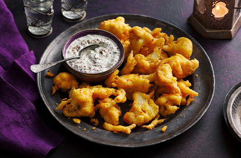 Gluten-free fried goodness! These cauliflower pakoras are easy to make for a big gathering and deliver tongue-tingling flavours