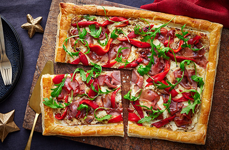Stretch prosciutto crudo and Parmesan further with this ham and cheese pastry tart traybake! This impressive centrepiece is sure to be a showstopper at any festive dinner party.