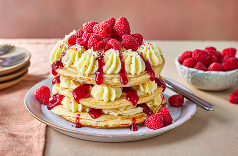 Birthday cake isn’t just for birthdays! These thick vanilla pancakes are stacked with layers of raspberry jam and buttercream. Top with sprinkles for extra luck.
