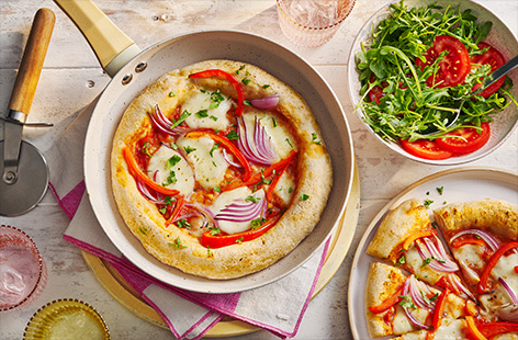 Bring a taste of Italy to the dinner table with this simple frying pan pizza recipe. Cook in a hot pan for a classic crispy base and finish under the grill for deliciously oozing cheese.  