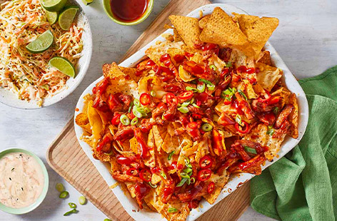 Whip up a homemade BBQ sauce with cupboard ingredients and use it to coat leftover roast pork in this fabulous nachos recipe, served with a fresh, crunchy slaw.