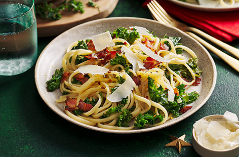 Eating your greens is easy with this simple pasta dish that's attractive to look at and delicious to eat. Smoky bacon, chilli, garlic and lemon provide the flavour, while soft linguine and wilted curly kale provide the texture. Finish with some Parmesan shavings, if you like.