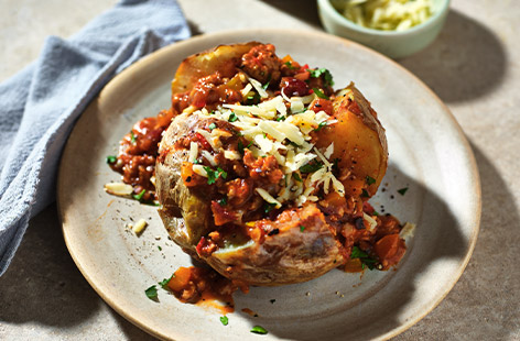 This gently-spiced chicken chilli is a really versatile meal. Serve with baked potatoes, as we've done here, or go for baked sweet potatoes. The chilli would also be great served with rice or couscous. Hearty, healthy and budget-friendly, it's the ultimate all-rounder!