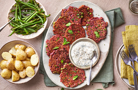 Fancy something different for tea tonight? Try these tasty, veg-packed fritters – the attractive pink colour comes from cooked beetroot. Serve with a minty crème fraîche dip, new potatoes and green beans. Ready in just half an hour, this healthy recipe is worth a try!
