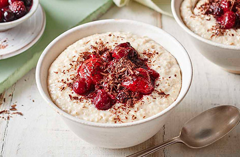 Start the morning with this tasty bowl of porridge swirled with berry compote and topped with a grating of dark chocolate - all of the delicious flavours of the retro Black Forest pud