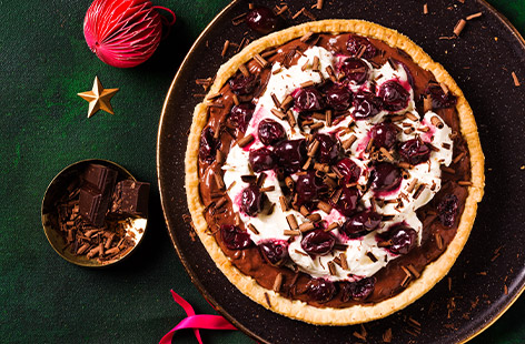Who doesn't love Black Forest gateau? So here's a tart inspired by Black Forest flavours, made from a readymade pastry case (no one will ever guess!). The filling of chocolate custard, black cherries in kirsch and double cream is luscious and indulgent, just as festive desserts should be!