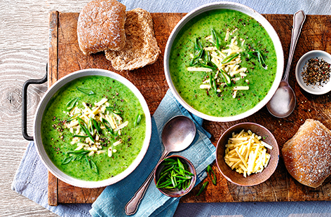 You really can't beat a bowl of hot soup on a cold day. This warming broccoli soup recipe is packed with fresh green vegetables, including baby spinach and spring onions, plus melted cheese for a creamy finish. Serve with a generous sprinkle of extra Cheddar and warmed bread rolls for dipping.