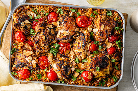Inspired by the flavours of butter chicken, this simple pilaf is made entirely in one tray. Bung all the ingredients in and let the oven do the hard work. Finish with a drizzle of cream and flaked almonds for those comforting butter chicken flavours.
