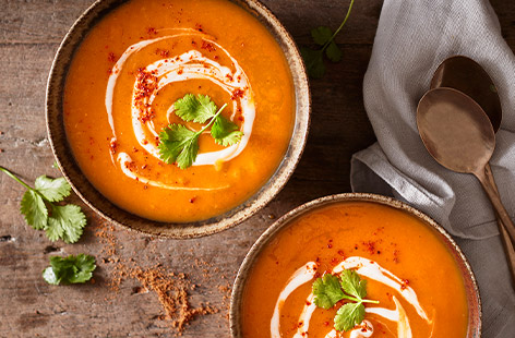 This vegan butternut squash soup is warmly spiced with Cajun seasoning and served with a swirl of coconut yogurt and fresh coriander.