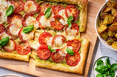 Top puff pastry with juicy tomatoes and creamy mozzarella for a fresh Mediterranean-inspired tart. Serve the tart with crispy pesto potatoes or a leafy green salad, if you fancy.  