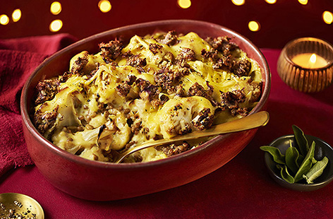 Who says cauliflower cheese is just a side? This veggie gratin with lentils and crispy sage and onion stuffing transforms this Christmas favourite into a hearty vegan main!