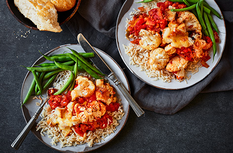 Make this cheesy tomato baked cauliflower recipe for an easy vegetarian dinner. Roast cauliflower (even the leaves!) until caramelised, then toss in tomato sauce and top with melting mozzarella.