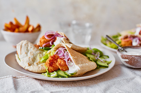 Treat the kids to a cheat's dinner with this super easy chicken nugget pittas recipe. Stuff toasted pittas with crispy nuggets, herby garlic cream cheese and plenty of salad for a quick dinner the whole family will love.