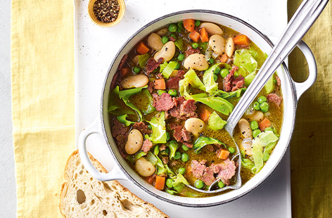 Turn corned beef into a hearty stew with vegetables and butter beans. Pesto and peas add freshness, serve with bread to mop it all up!