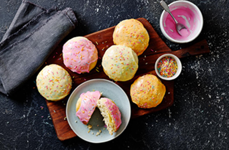 In Denmark, Fastelavn buns are eaten during the Shrovetide celebration of Fastelavn, the buns are filled with custard and marzipan, then finished with whipped cream and colourful icing.