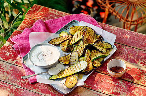 This simple yet impressive side dish is a great vegetarian addition to any barbecue spread. Simply dressed courgette and aubergine are griddled and served with creamy whipped feta and yoghurt in this easy recipe.
