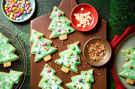 Everyone loves a Christmassy biscuit and it would be hard to find a more fun, festive bake than these oh-so-cute Christmas trees. The biscuit is flavoured with delicate spices and vanilla and topped with icing, sweets and treats. Let the fun begin!