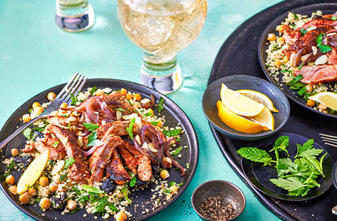 Slices of tender lamb sit on top a bed of couscous – with chickpeas, prunes and herbs – in this speedy fakeaway recipe for four people