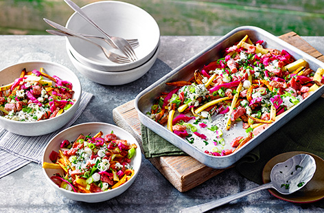 Turn fries into dinner with this loaded sweet potato and parsnip fries recipe. Topped with crispy bacon, a creamy blue cheese sauce and tangy pickled cabbage, this is a meal everyone can enjoy.
