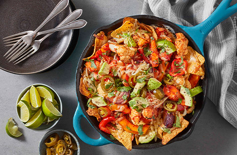 Raid the veg drawer for these veggie-loaded nachos which are spiced with fajita seasoning and topped with mozzarella, jalapeños and lime. Get stuck in! 