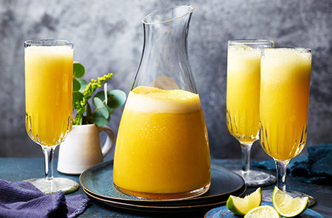 The perfect summer cocktail that's both cooling and refreshing; mango sorbet is blitzed with vodka and lime then topped with prosecco.