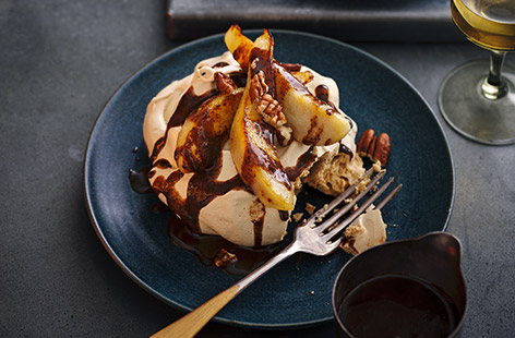 Sweet meringues lie under sharp Conference pears and a drizzle of spiced chocolate caramel sauce