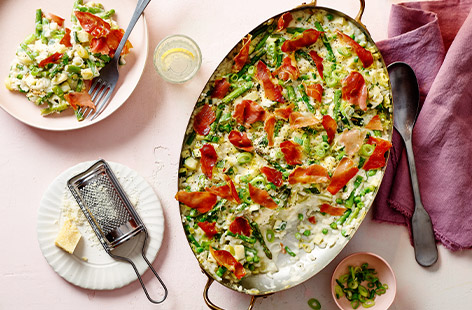 With crispy prosciutto and lots of greens, this risotto primavera is sure to impress. Unlike normal risotto recipes, this one is baked, which means less time stirring!