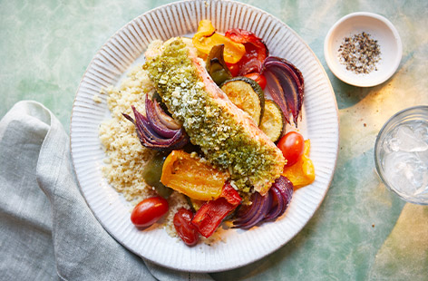 Give your salmon a Mediterranean-inspired glow-up with a jar of pesto and vibrant roasted veggies. Use any leftovers to make a summery tart with puff pastry for tomorrow's dinner.