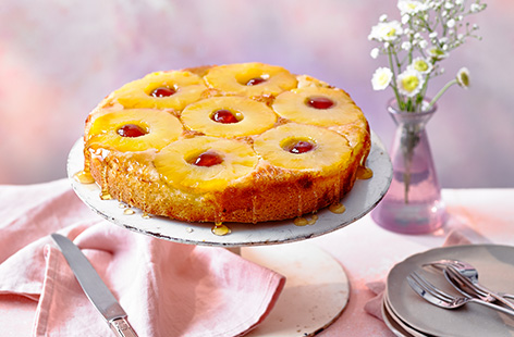 This pineapple upside-down cake recipe is a retro baking classic. The light and fluffy sponge is topped with juicy pineapple slices and glacé cherries for a traditional weekend bake - serve warm with custard for dessert.