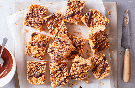 Use a box of classic rice crispies to create these sweet treats, made with smooth peanut butter and honey, dotted with dried apricots and drizzled with a little dark chocolate.