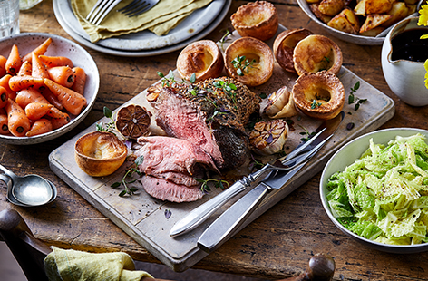 Get the family together for a feast; everyone will enjoy our classic roast beef recipe with Yorkshire puddings, carrots, cabbage and red wine gravy