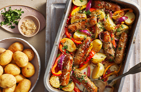 This sausage traybake is the perfect one-pan midweek meal. Crispy Jersey Royal potatoes, sausages and vibrant peppers are baked in a zesty lime and coriander vinaigrette and topped with a scatter of toasted sesame seeds to finish.