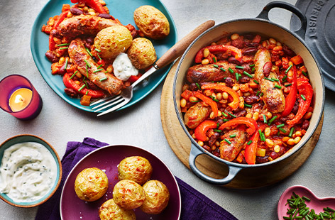 Fuel the family with this comforting bangers and beans dish. Sausages and bacon are cooked with mixed beans in a BBQ-flavoured tomato sauce. Serve with soured cream and chive dip.
