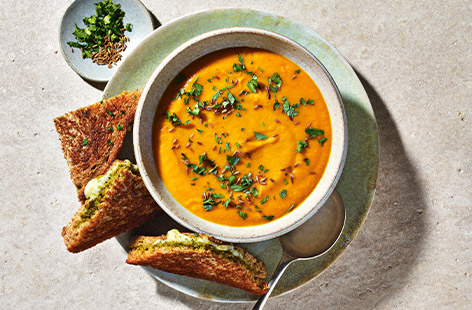 This carrot soup recipe is a cut above! Gently spiced to complement the sweetness of the carrot, with lentils for added creaminess, this is a wholesome winter warmer. Add the cheesy pesto toasties and you've got a feast! So simple to make, this is perfect midweek or Sunday night comfort food.