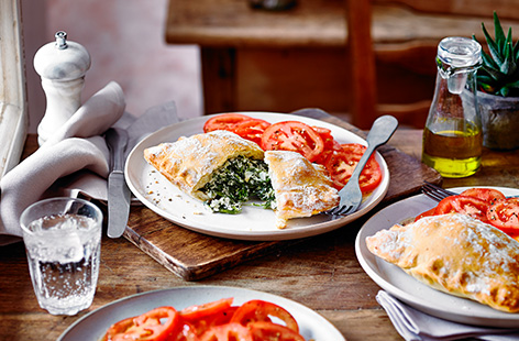 Give pizza night a twist and try this spinach and ricotta calzone recipe. The cheesy spinach filling is wrapped in ready-made pizza dough for an easy midweek meal - add a simple tomato salad and dinner is served!