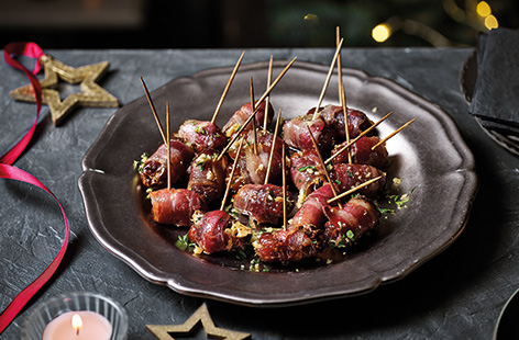 Serve up sticky maple glazed bacon-wrapped dates for a crowd-pleasing canapé. The irresistible combination of sweet sticky dates, crispy glazed bacon and a herby walnut filling ensure that these will disappear in no time.
