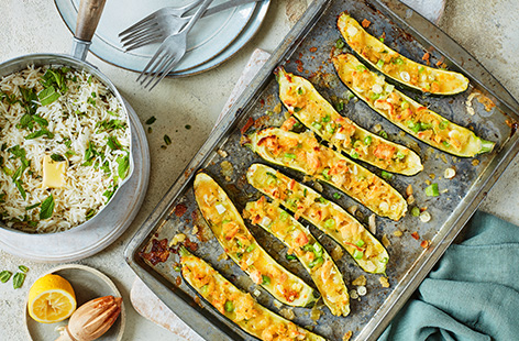 Make the most of courgettes this summer with this stuffed courgettes recipe, perfect for a weekend lunch or light summer dinner. Fill grilled courgettes with melting cheese, spring onions and crispy croutons, then serve with fragrant mint and lemon rice.