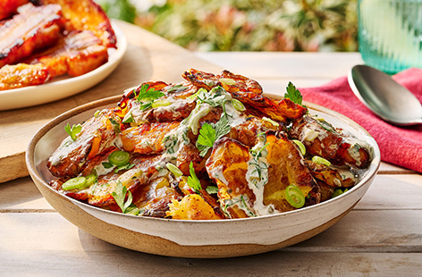 Take classic potato salad to the next level with our extra-crispy version using roast potatoes. The dressing is made with yogurt and mayo, plus capers and mustard to cut through the creaminess. It's a great addition to a BBQ and tastes great hot or cold!