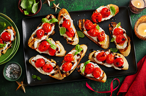 Take your party food to the next level with these elegant bruschetta bites. Roasted garlic is stirred through ricotta with lemon, then piled onto toasted crostini with roasted tomatoes. Finish with a drizzle of balsamic glaze and serve up at your next Christmas party. 