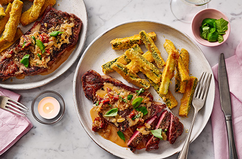 Wondering what to cook for Valentine's Day? This extra-special steak is topped with a creamy sundried tomato sauce that tastes so good someone might ask you to marry them! Serve alongside crispy Parmesan and polenta courgette fries for an unforgettable date night dinner. 