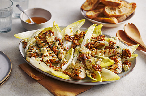 Griddled pears and chicory are topped with crumbled blue cheese and caramelised walnuts to make this wonderful winter salad. 